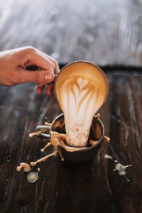 pouring coffee into another cup